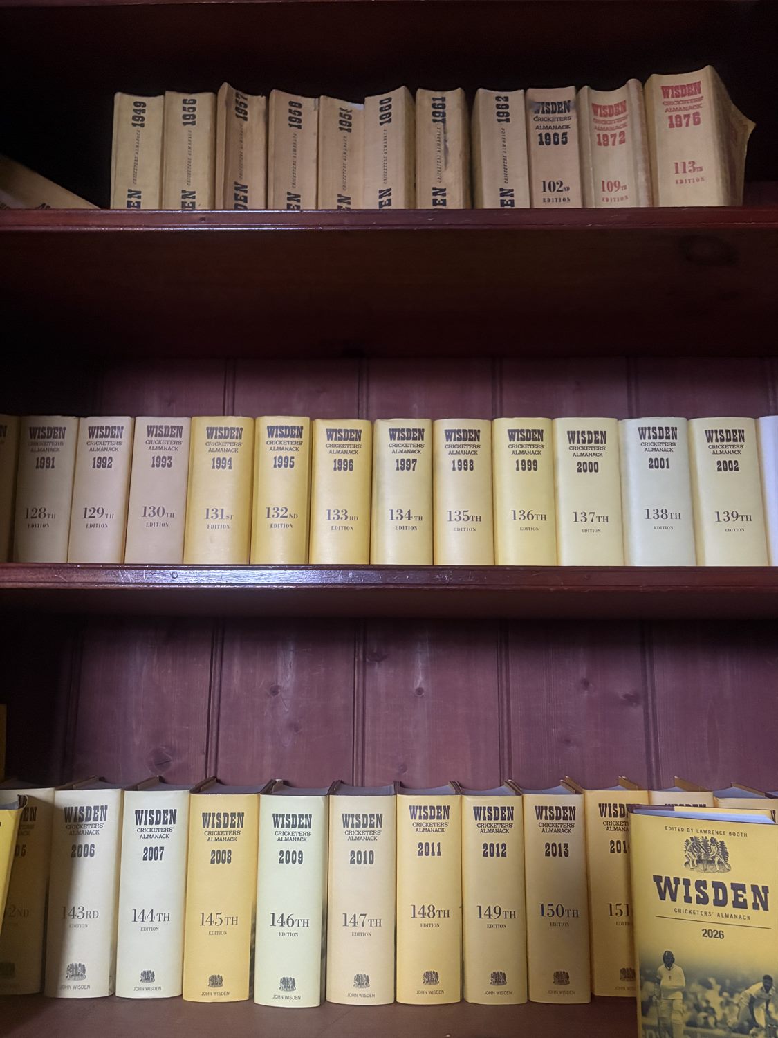 Shelves holding decades of the Wisden Cricketers' Almanack